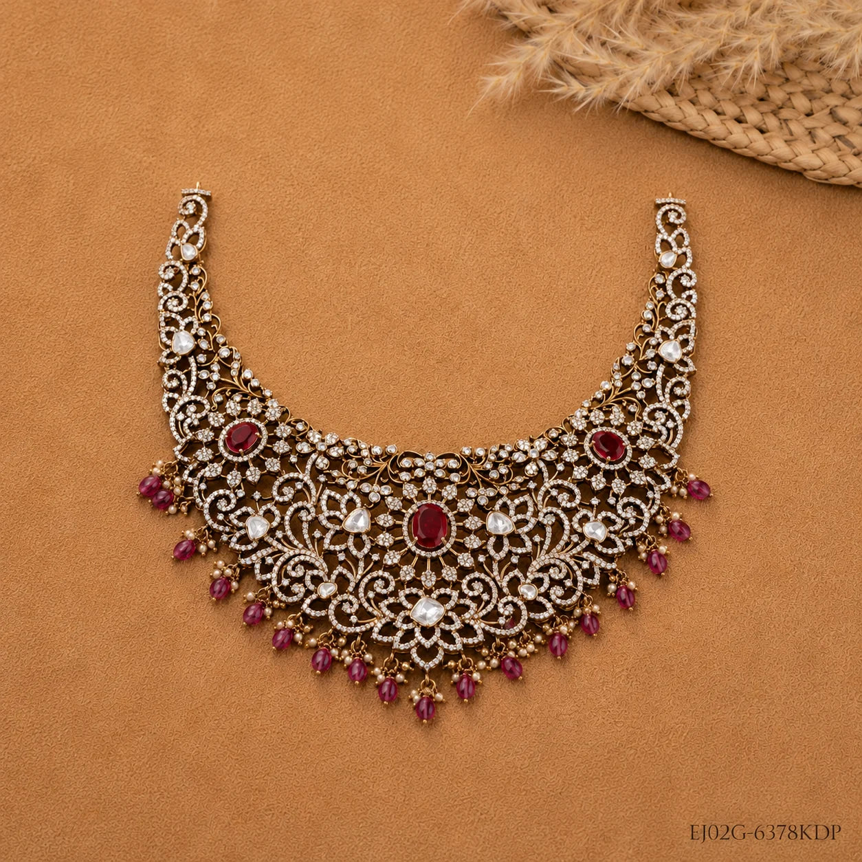 Flat lay close-up of necklace highlighting antique finish, cubic zirconia florals and red beads