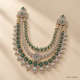 Full view of the green long necklace with shoulder pieces and temple-style drops, lit with soft daylight