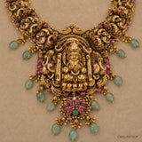 Close-up of the goddess pendant with pink stone detailing, cubic zirconia work and green teardrop bead drops