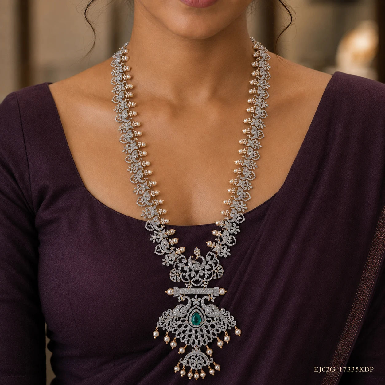 Long necklace displayed on beige fabric beside dried flowers, showing the complete design